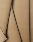 Tan velveteen upholstery fabric by the yard, folded showing drape and weight