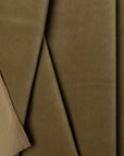 Olive green velveteen upholstery fabric by the yard, folded showing drape and weight