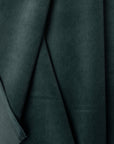 Blue-green velveteen upholstery fabric by the yard, folded showing drape and weight