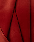 Red velveteen upholstery fabric by the yard, folded showing drape and weight