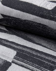 Black and gray abstract jacquard upholstery fabric by the yard, rolled bolt view