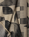 Champagne and black abstract jacquard upholstery fabric by the yard, folded showing drape and weight