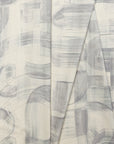 Gray and cream abstract printed linen fabric by the yard, folded showing drape and weight