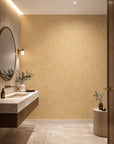 Golden yellow feather print wallpaper installed in a powder room
