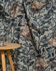 Dusky blue and coral floral printed linen fabric by the yard, draped to show pattern and scale