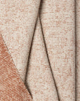 Terracotta marled chenille outdoor fabric by the yard, folded showing drape and weight