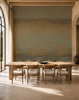 Khaki and gray-blue ombre mural wallpaper installed in a sunlit dining room