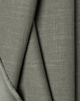 Green linen upholstery fabric by the yard, folded showing drape and weight
