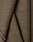 Green linen upholstery fabric by the yard, folded showing drape and weight
