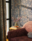 Blue floral commercial wallcovering hung on the wall by a window in a sitting room