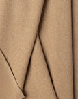 Beige boucle upholstery fabric by the yard, folded showing drape and weight
