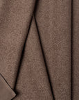 Brown boucle upholstery fabric by the yard, folded showing drape and weight