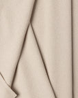 Cream boucle upholstery fabric by the yard, folded showing drape and weight