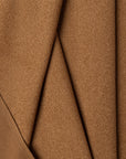 Brown boucle upholstery fabric by the yard, folded showing drape and weight