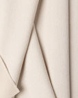 White boucle upholstery fabric by the yard, folded showing drape and weight