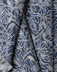 Blue and cream botanical leaf jacquard upholstery fabric by the yard, folded showing drape and weight