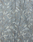 Blue botanical leaf printed linen fabric by the yard, folded showing drape and weight