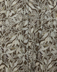 Brown and cream botanical leaf printed linen fabric by the yard, folded showing drape and weight