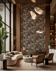 Multicolor fruit and floral botanical on black wallpaper installed in a double-height lounge