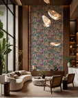 Magenta and teal fruit and floral botanical wallpaper installed in a double-height lounge