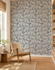 Black and white abstract squiggle commercial wallcovering installed in a sunlit reading nook