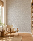 Light gray and white abstract squiggle wallpaper installed in a sunlit reading nook