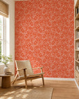 Orange-red and white abstract squiggle commercial wallcovering installed in a sunlit reading nook