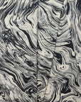 Black and cream marbled abstract linen fabric by the yard, folded showing drape and weight
