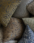 Sage green botanical leaf throw pillow shown with Poppy Print Studio pillow collection on white boucle sofa