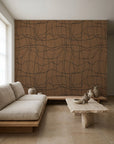 Black hand-drawn grid on brown commercial wallcovering installed in a minimalist living room