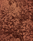 Warm-toned botanical wallpaper featuring hand-drawn foliage in dark brown against a terracotta background, creating a vintage-inspired aesthetic.