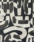 Close-up of black and white abstract wallpaper with bold, sweeping brushstrokes creating a dynamic, modern pattern.