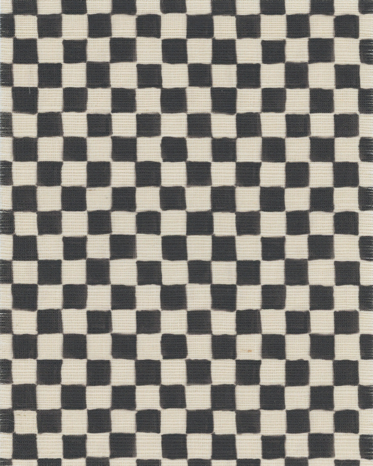 Close-up of black and white checkered grasscloth wallpaper with a woven texture, featuring subtle irregularities in the pattern for a handcrafted look.