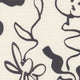 Close-up of grasscloth wallpaper featuring an black floral line drawing on a textured off-white background.