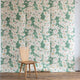 Floral grasscloth wallpaper with green background and wooden chair in front