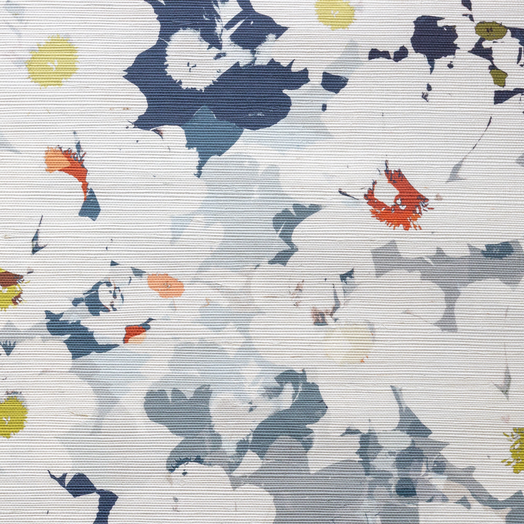 Close up detail photo of sisal grasscloth with colorful abstract flower pattern on a dark blue and grey background