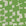 A close-up of geometric-patterned grasscloth wallpaper in vibrant green and off-white, featuring irregularly shaped blocks creating an abstract, modern design.