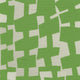 A close-up of geometric-patterned grasscloth wallpaper in vibrant green and off-white, featuring irregularly shaped blocks creating an abstract, modern design.