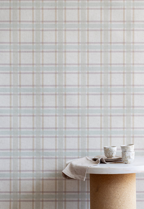 Serene interior scene with a marble and cork table set in front of a pastel plaid wallpaper, creating a light and airy atmosphere.