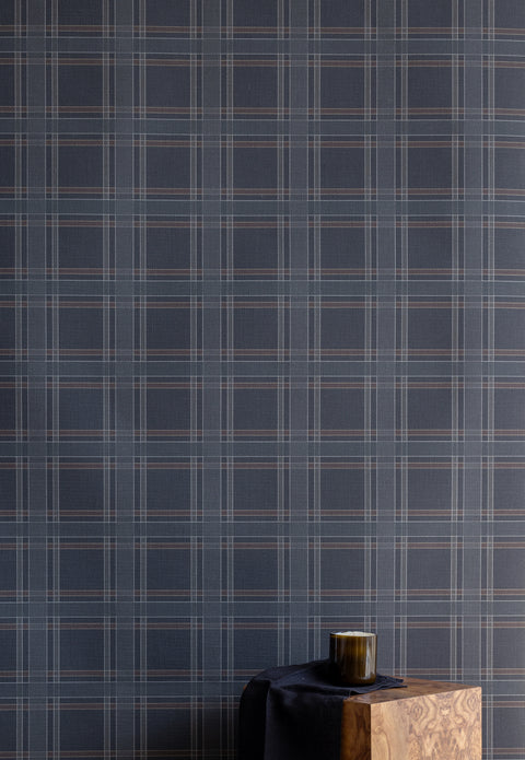  Interior scene with a wooden block table and dark accessories set against a moody charcoal plaid wallpaper for a refined, masculine look.