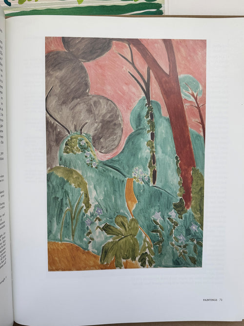 Printed page featuring a painting of a lush, stylized landscape with green foliage, abstract tree forms, and a soft pink sky, rendered in an expressive, modernist style