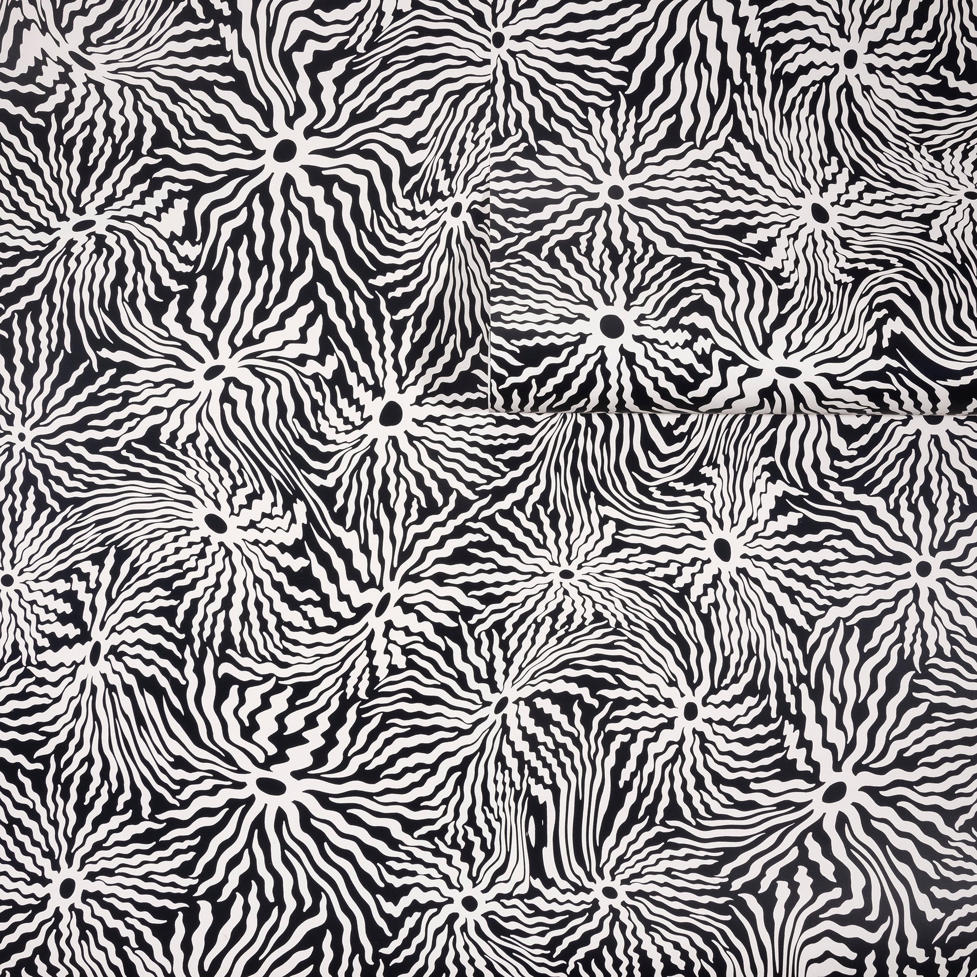 Black and white wallpaper with an abstract swirling pattern of wavy lines radiating
from circular centers, partially unrolled for texture display.