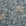 Full view of a silk wallpaper with a detailed floral and leafy pattern in muted blue tones on a soft grayish-blue background, creating a painterly effect.