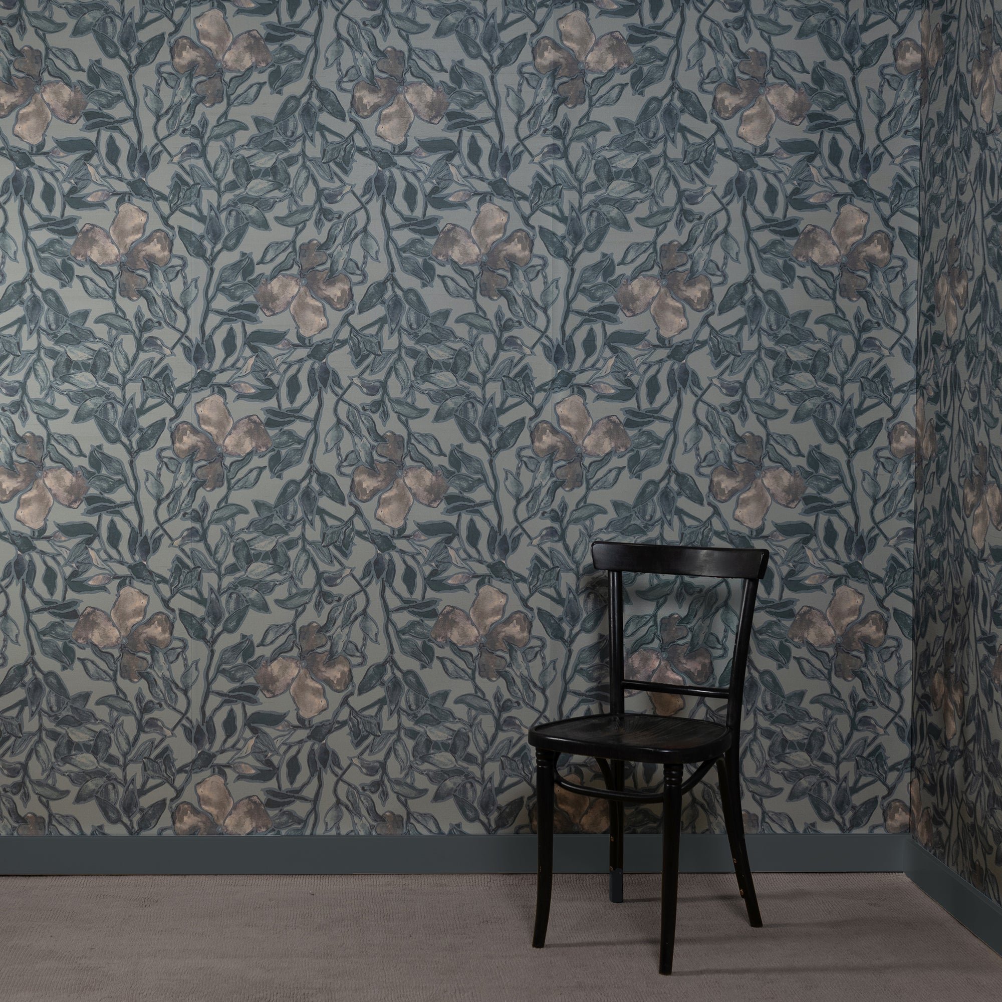 Room with silk wallpaper featuring a hand-painted botanical design in muted blue and beige tones, depicting delicate leaves and flowers, complemented by a black wooden chair in the corner.