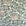 Silk wallpaper with a botanical design in green and beige tones, featuring hand-painted leaves and flowers on a light, neutral background.