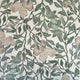 Silk wallpaper with a botanical design in green and beige tones, featuring hand-painted leaves and flowers on a light, neutral background.