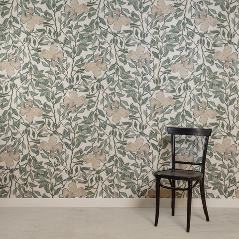 Room with silk wallpaper featuring a delicate botanical design in soft green and beige tones on a white background, depicting hand-painted flowers and leafy vines, complemented by a black wooden chair.