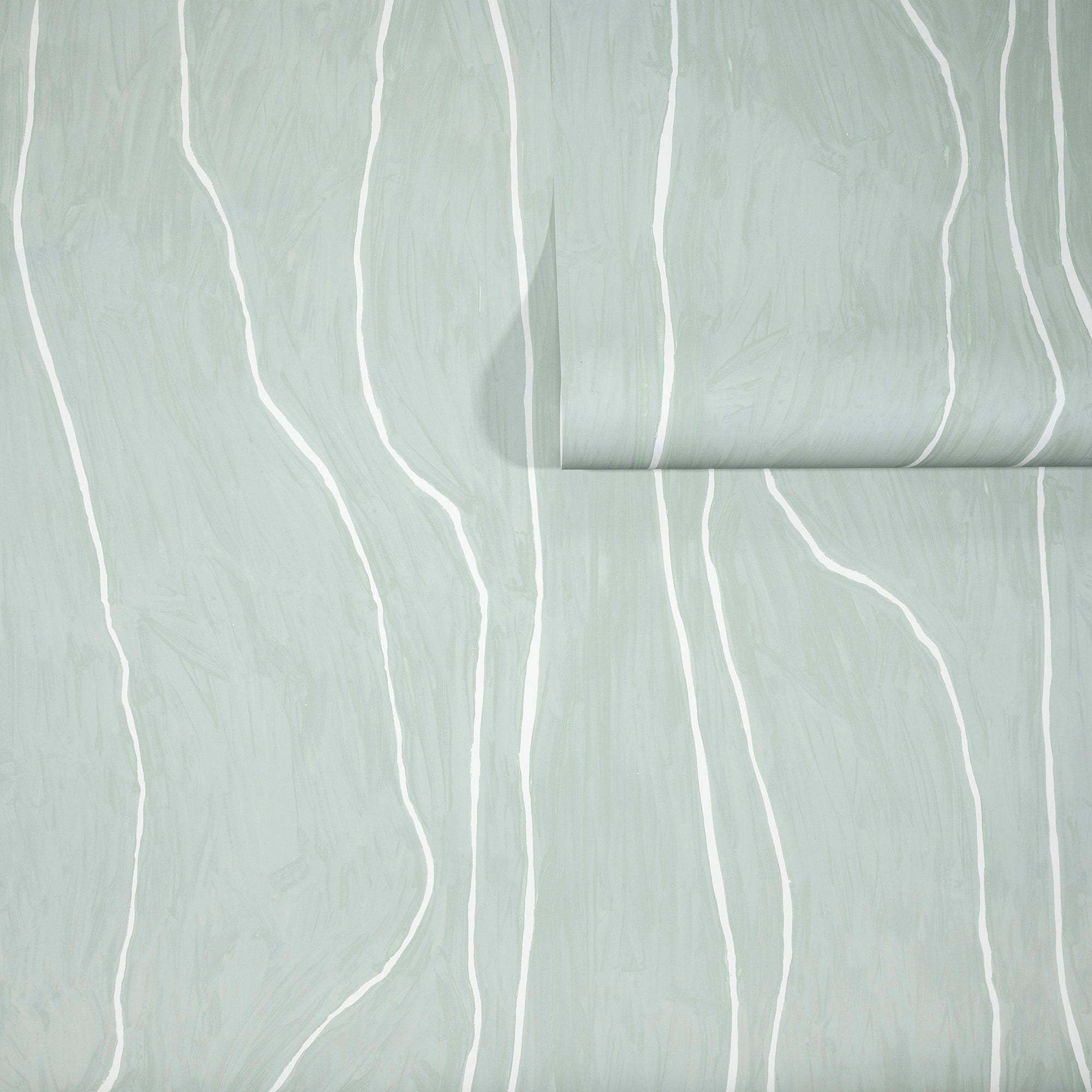 Soft sage green wallpaper with abstract white vertical wavy lines, partially unrolled to reveal texture and pattern.