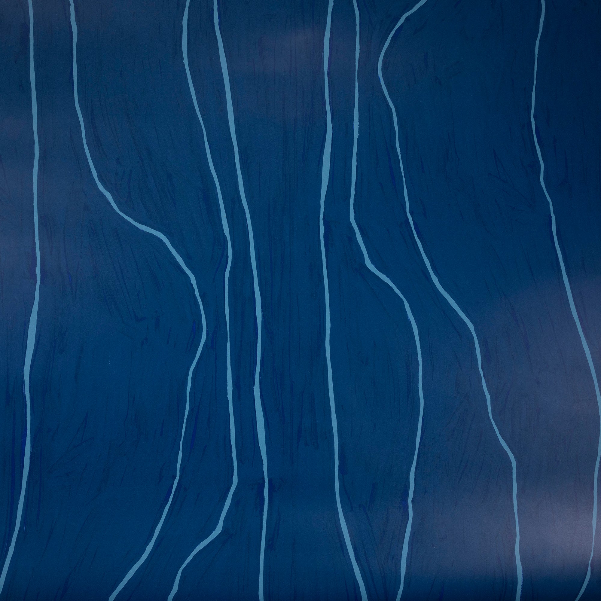 Close-up of navy blue wallpaper featuring free-flowing light blue vertical lines, creating an organic, modern aesthetic.