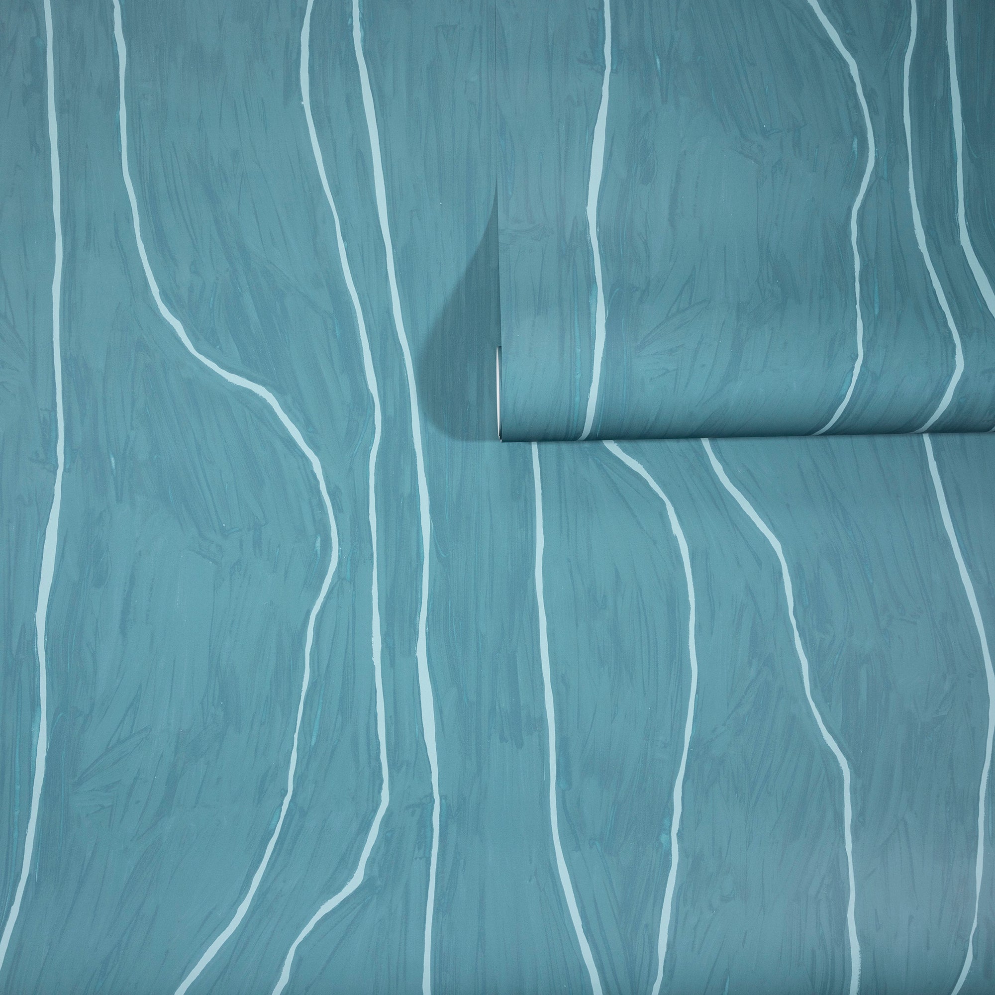 Muted teal wallpaper with abstract white vertical wavy lines, partially unrolled to reveal the organic, flowing pattern